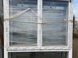 a white window with a blue top on a pallet next to a truck