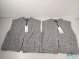 two gray sweaters sitting on top of each other on a table