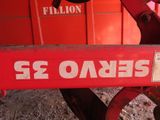 a close up of a red tractor with a sign on it