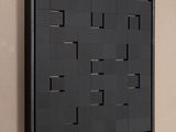 a picture of a black wall hanging on a beige wall