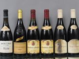 several bottles of wine are lined up in a row on a table