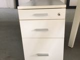 an image of a white filing cabinet in a garage