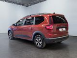 the rear end of a red car parked in a showroom