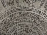 a close up of a metal plate with designs on it