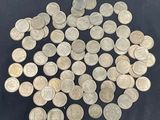 some silver coins are arranged in a circle on a black surface