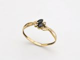 an image of a gold ring with a black diamond