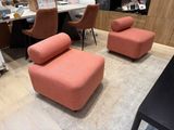 two chairs and a ottoman in the middle of a room