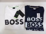 two t - shirts with the word boss on them are sitting on a table