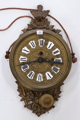 a clock with roman numerals hanging on the wall
