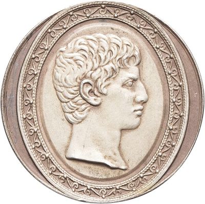an old silver coin with a woman ' s profile in the center