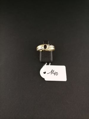a close up of two rings on a black surface with a price tag