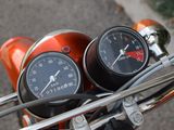 two gauges on the handlebars of a motorcycle