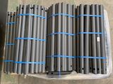 a bunch of pipes sitting on top of a pallet in a warehouse