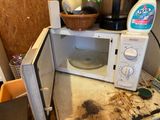 a microwave that has a lot of dirt on it