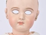 a close up of a doll wearing a white dress
