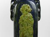 a blue and green vase with a picture of a woman on it