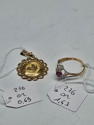 two gold rings and two silver rings with price tags on them