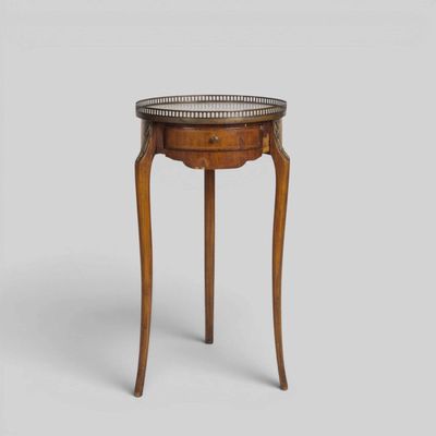 a small wooden table with a metal top on a white background