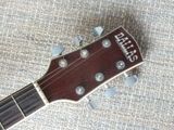 an overhead view of a guitar neck with the frets on it