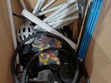 a box full of assorted skis and ski poles
