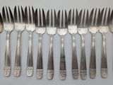 six forks and six knives are arranged in a row
