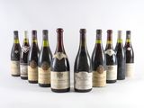 six bottles of wine are lined up in a row on a white surface