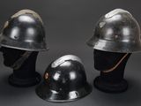 three helmets are sitting on top of each other on a black surface