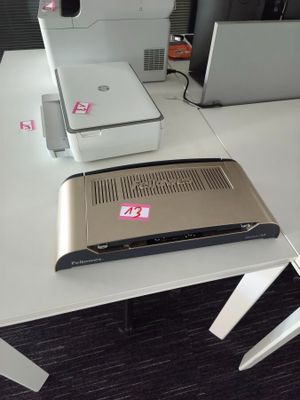 a laptop and a printer sitting on a white desk