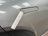 a sticker on the hood of a car that is parked in a parking lot