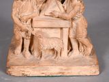 a statue of a group of people sitting at a table