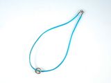 blue leather necklace with a silver ring on a white background