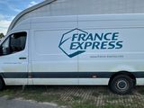 a white van that is parked in front of a building