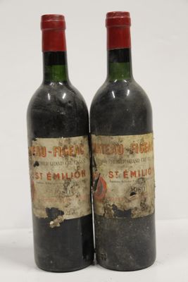 two bottles of wine sitting next to each other on a white surface
