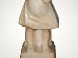 marble statue of a young girl holding a book