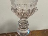 a clear glass cup sitting on a table next to a book