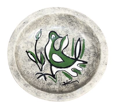 a plate with a bird painted on it on a white background