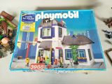 a box of playmobil on a table with other toys