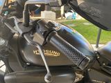 a black motorcycle parked in front of a garage
