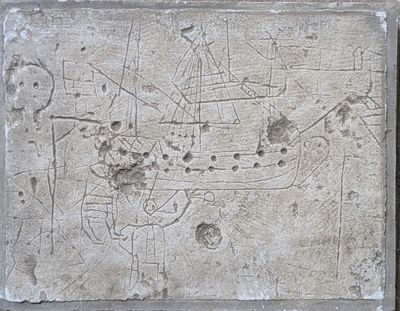 a stone plaque with a drawing of a boat on it