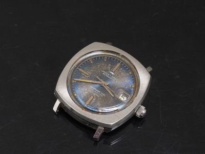 a watch that is sitting on a black surface