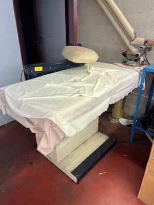 a table with a sheet on it in a room