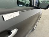a car that has a sticker on the side of it ' s door