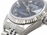 a watch with a blue dial on a silver bracelet
