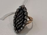 a close up of a black and white diamond ring on a white surface