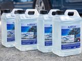 four bottles of airblue on the ground next to a blue car