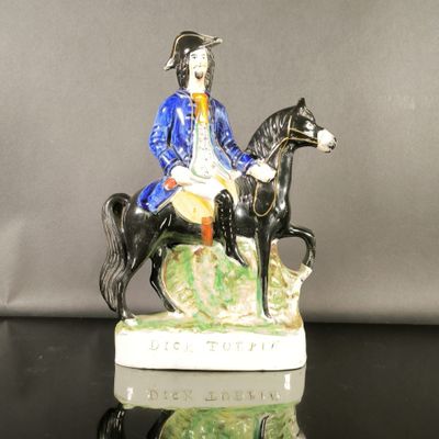 a figurine of a man riding a horse on a rock