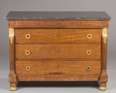 an antique chest of drawers with marble top and brass handles