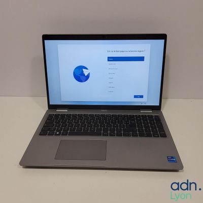 an open laptop computer sitting on top of a table next to a mouse