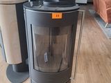 a glass stove in the middle of a living room
