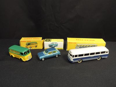 three toy cars and a bus are sitting next to each other